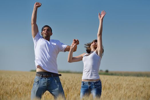 happy young couple in love have romance and fun at wheat field in summer