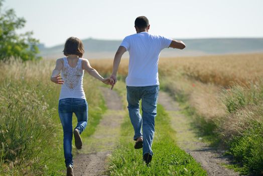 happy young couple in love have romance and fun at wheat field in summer