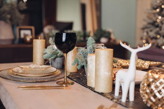 Christmas table in the living room with the objects of holiday decor. New Year eve concept