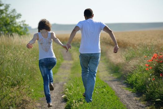 happy young couple in love have romance and fun at wheat field in summer