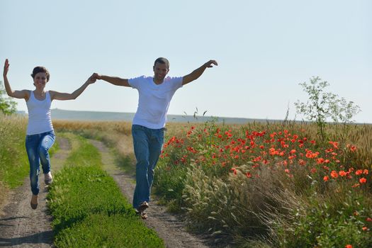 happy young couple in love have romance and fun at wheat field in summer