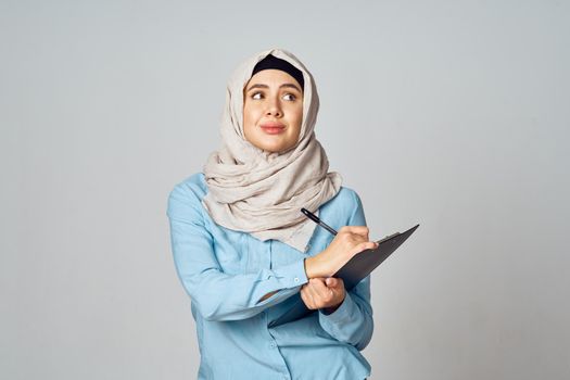 Muslim woman in hijab documents office work. High quality photo