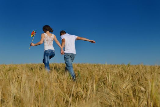 happy young couple in love have romance and fun at wheat field in summer