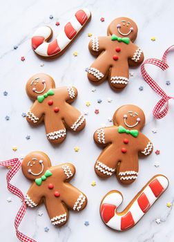Christmas gingerbread cookies on a white marble background. Homemade delicious Christmas gingerbread