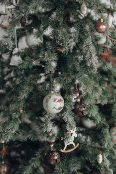Stock photo of beautiful decorated Christmas tree with blue and silver and white balls and wrapped Christmas presents under the tree. Two Santa Claus figures under tree.