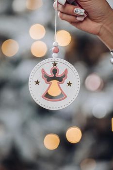 Cropped photo of lady holding beautiful decoration for Christmas tree. New Year eve concept