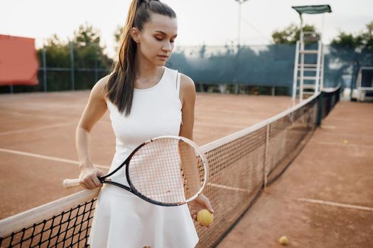 Young beautiful woman tennis player with racket. High quality photo