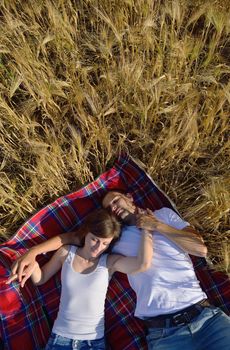 happy young couple in love have romance and fun at wheat field in summer