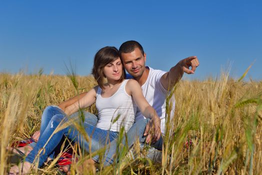 happy young couple in love have romance and fun at wheat field in summer