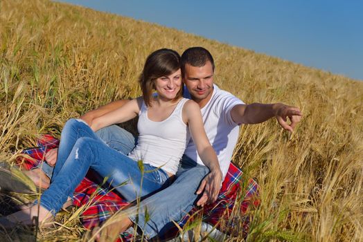 happy young couple in love have romance and fun at wheat field in summer