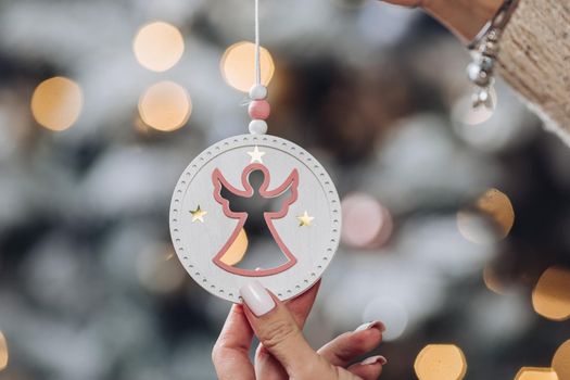 Cropped photo of lady holding beautiful decoration for Christmas tree. New Year eve concept