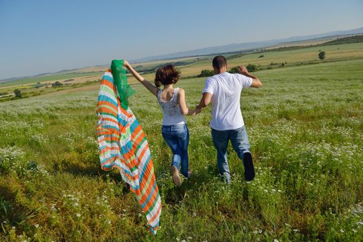 happy young couple in love have romance and fun at wheat field in summer