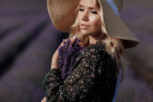Fashion portrait of a pretty young woman in lavender field. High quality photo