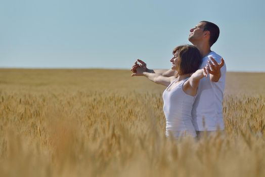 happy young couple in love have romance and fun at wheat field in summer