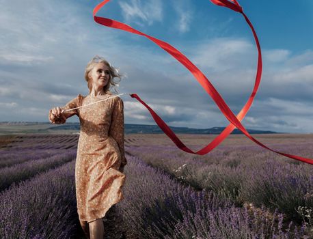 Fashion portrait of a pretty young woman in lavender field. High quality photo