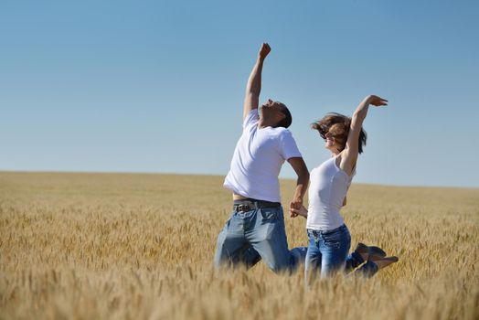 happy young couple in love have romance and fun at wheat field in summer