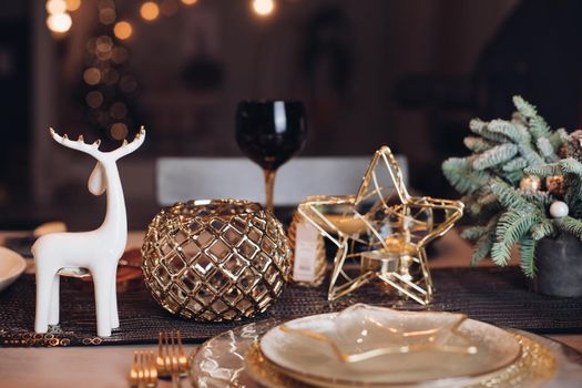 Christmas table in the living room with the objects of holiday decor. New Year eve concept