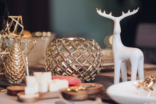 Christmas table in the living room with the objects of holiday decor. New Year eve concept