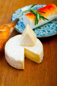 French cheese and fresh  baguette on a wood cutter