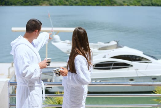 Romantic young couple spending time together and relaxing on yacht