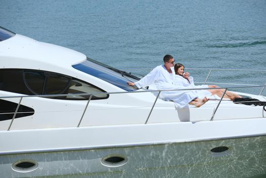 Romantic young couple spending time together and relaxing on yacht