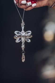 Cropped photo of lady holding beautiful decoration for Christmas tree. New Year eve concept