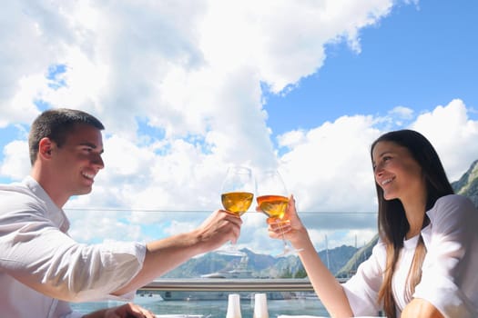 happy young couple having lanch at beautiful restaurant on the beach