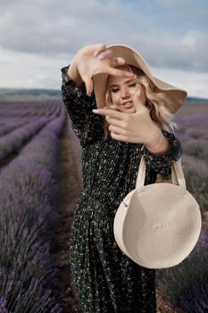 Fashion portrait of a pretty young woman in lavender field. High quality photo