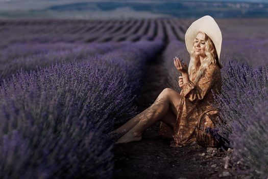 Fashion portrait of a pretty young woman in lavender field. High quality photo