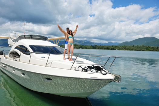 Romantic young couple spending time together and relaxing on yacht