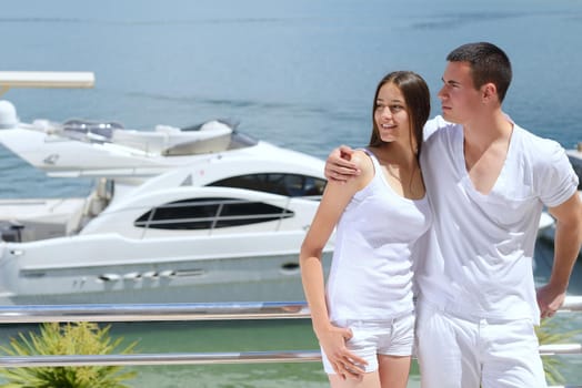 Romantic young couple spending time together and relaxing on yacht