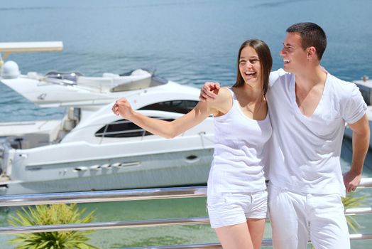 Romantic young couple spending time together and relaxing on yacht