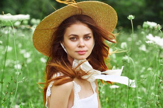 pretty woman with hat nature field flowers fresh air. High quality photo