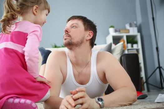 Portrait of father and daughter spending time together at home on holiday. Child spend quality time with parent. Childhood, parenthood, leisure concept