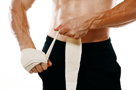 athletic male muscled naked torso boxer fitness exercise bandaged arm. High quality photo