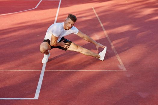 man on the sports ground exercise warm-up lifestyle. High quality photo