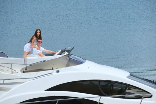 Romantic young couple spending time together and relaxing on yacht