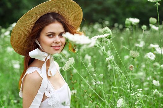 Woman with hat white dress flowers nature relaxation. High quality photo