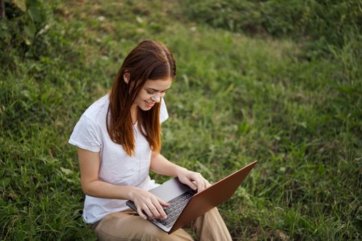 cheerful woman outdoors laptops communication internet. High quality photo