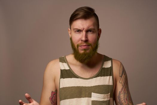 national bearded man in a striped jersey hipster tattoos on his arms. High quality photo