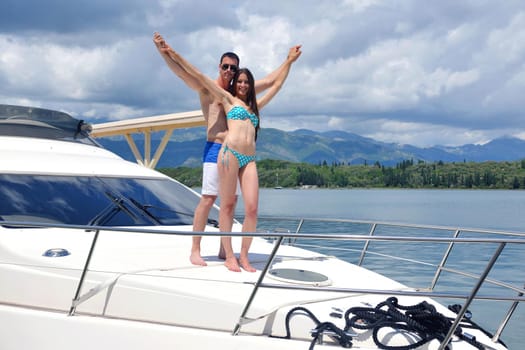 Romantic young couple spending time together and relaxing on yacht