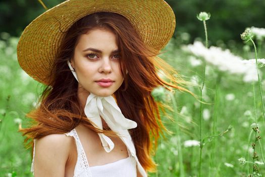 pretty woman with hat nature field flowers fresh air. High quality photo