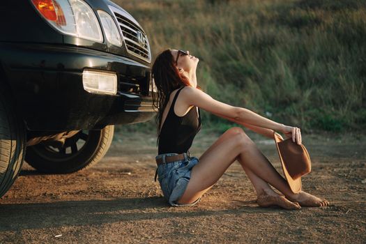 woman in sunglasses near car travel summer vacation landscape. High quality photo