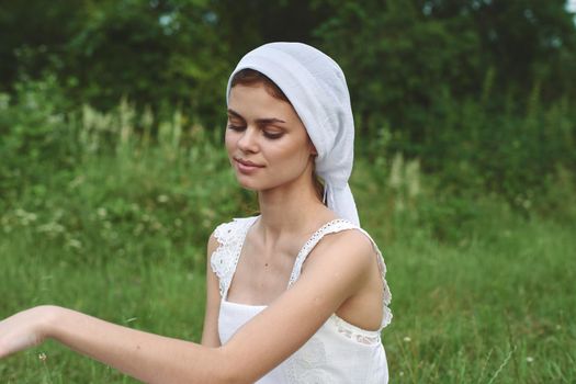 Woman in white dress in the village outdoors Green grass Farmer. High quality photo