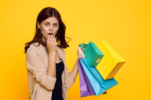 cheerful woman shopping entertainment lifestyle yellow background. High quality photo