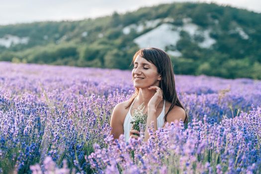 Lavender flower blooming scented fields in endless rows. Selective focus on Bushes of lavender purple aromatic flowers at lavender field. Abstract blur for background.