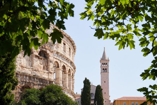 Pula, Croatia. Picturesque ancient Roman amphitheater arena and Saint Anthony church