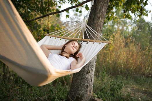 woman sleeping in hammock outdoors leisure lifestyle. High quality photo