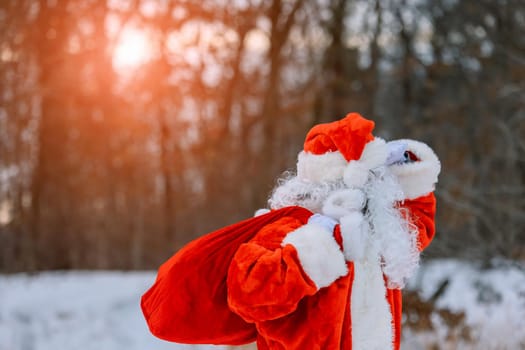 Magnificent snow covered landscape Santa Claus carrying Merry Christmas present gifts to children