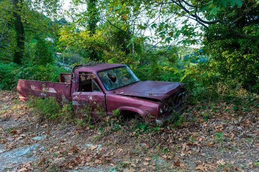 Pelion, Greece - August 13 2020: Old crashed car in the forest, Greece